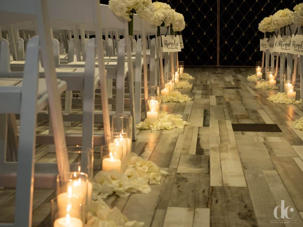 Wedding aisle with candles and flower petals