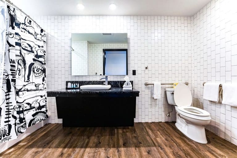 Corner suite bathroom with white tiles