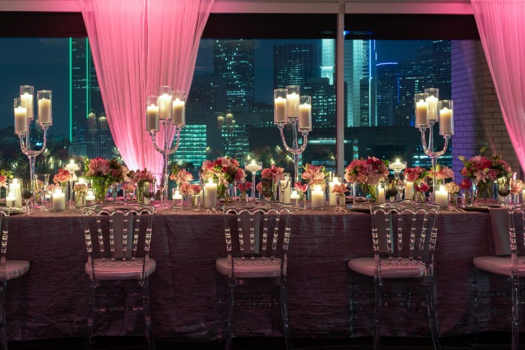 Decorated table in our Dallas event venue overlooking night-time downtown