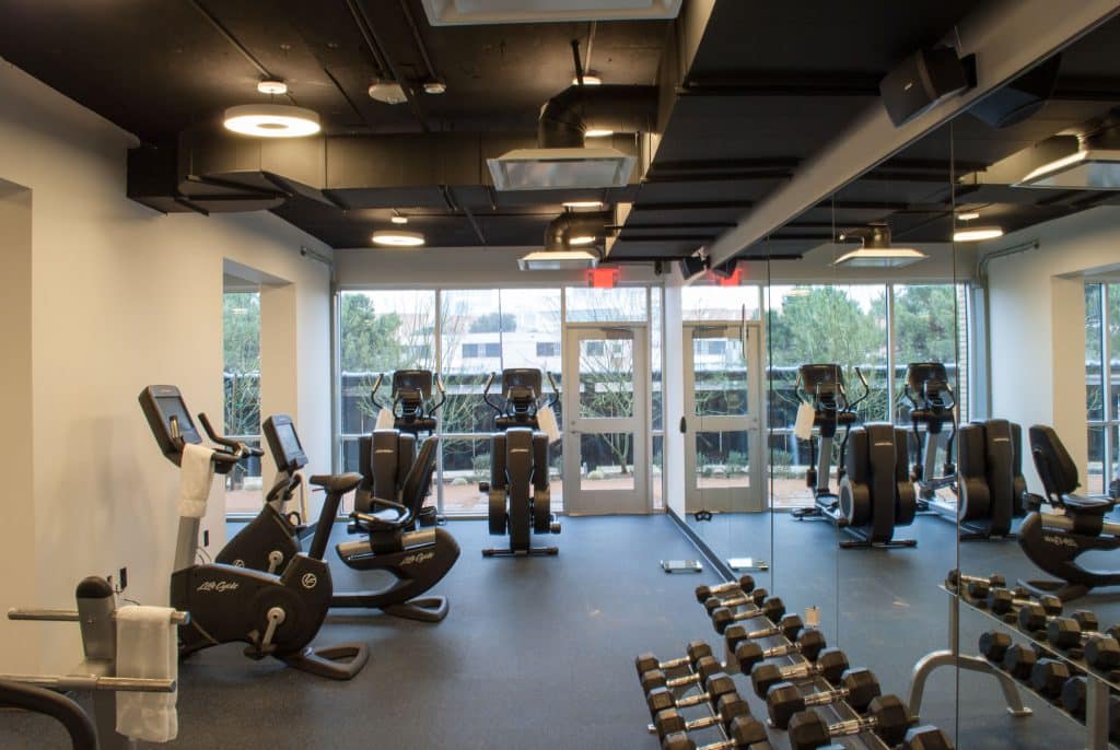 Fitness center with elliptical machines and free weights at our Dallas hotel