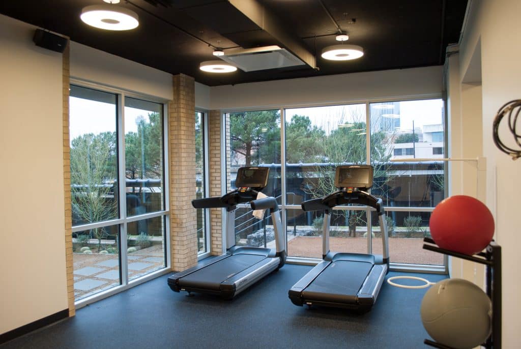 Two treadmills in front of floor-to-ceiling windows at our Dallas hotel