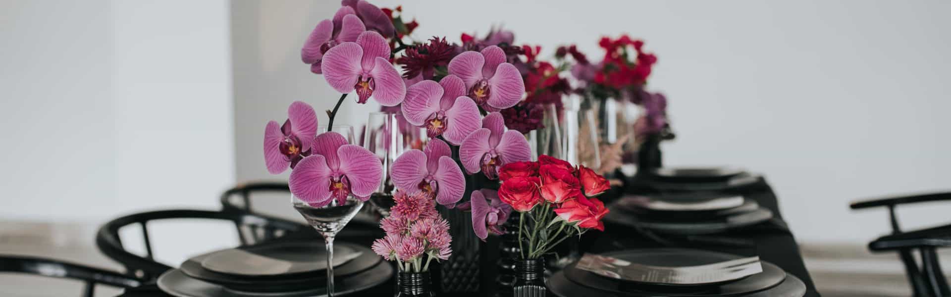 Black table setup with pink flowers
