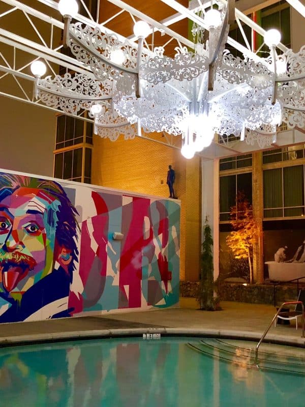 The best hotel pool in Dallas, featuring a colorful Albert Einstein mural
